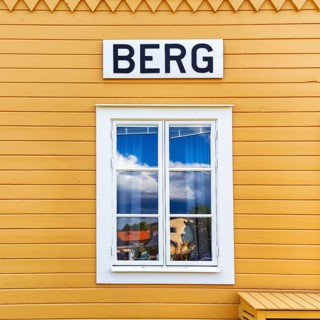 Facade detail with window, yellow wooden house, lock keeper's house, sign with inscription, lock