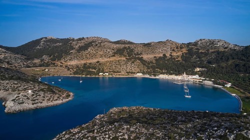 Drone shot, Picturesque bay with sailing boats and surrounded by rocky mountains, Holy Week, Bay of