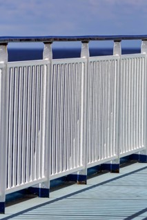 Sturdy railing, railing on the outer deck of a ferry, vertical bars, continuous handrail, safety,