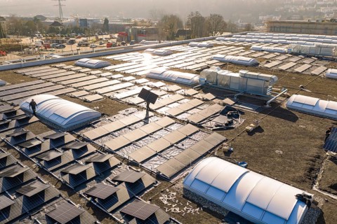 Large-scale installation of solar systems on a roof in sunny weather, PV Bau Auf OBI Bau Markt,