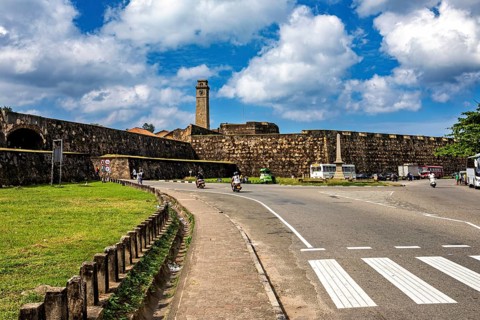 Street scene with an old fortress in the background and blue sky, The fortress of Galle in Sri