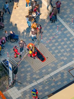 Rescue simulation with people on a paved square from above, opening hospital, Calw, Germany