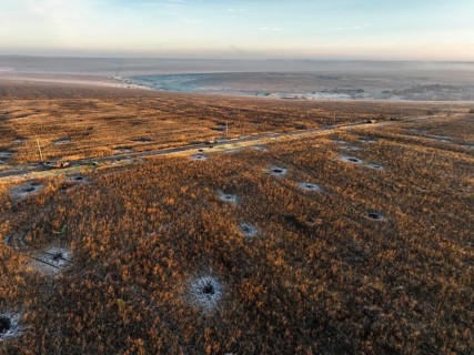 Top view of a desolate area impacted by the war in Ukraine, captured by drone. Late afternoon