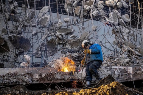 Workers with cutting torches demolishing the 120-meter long motorway bridge of the A516, across
