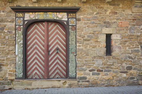 Gate dated 1771 and decorations, flank tower, wood carving, building, Goslar, Harz, Lower Saxony,