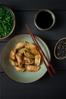 Japanese fried gyoza dumplings, with pork, sesame seeds, green onions