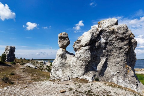 Raukar, limestone pillars, mythical creatures, coastline, Cumulus, uninhabited island of Asunden,