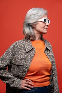 Asian Chinese senior woman exudes confidence with her stylish gray hair, wearing a leopard print