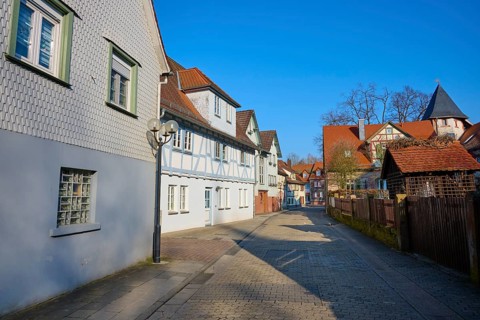 Paved alley lined with half-timbered houses overlooking a clear sky, Am Schlossgraben, Erbach,