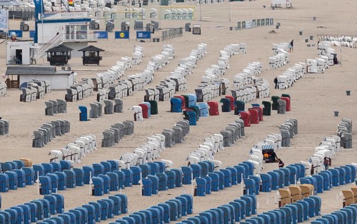 Rows of beach chairs in blue, red and white on a sandy beach, Warnemünde, Rostock,