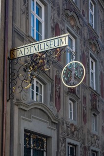 Detailed view, façade painting from Haus zum Cavazzen with artfully decorated nose sign with the