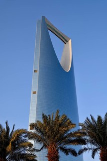 Palm trees in front of the mirrored facade of the Kingdom Center, Riyadh, Saudi Arabia