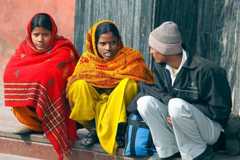 New Delhi, India, 15.01.10 - Two woman in traditional Indian clothes and an Indian man wait at the