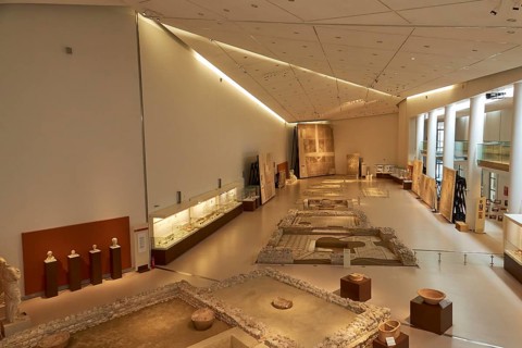 Exhibition room in the museum with artifacts, sculptures and discreet lighting, Patras