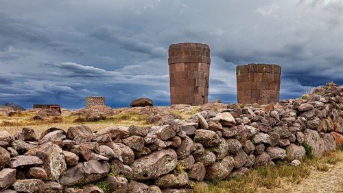 Dramatic clouds over old stone towers and walls, The Chullpas of Sillustani near Puno in Peru