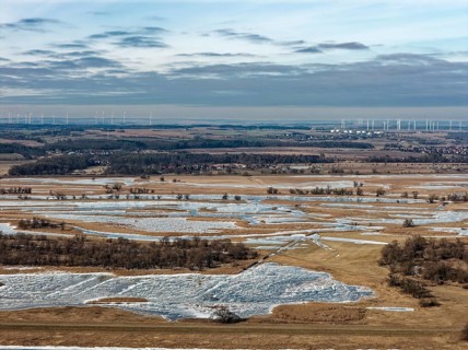 Ice and snow-covered foothills of the Oder in the Lower Oder Valley National Park. aerial view.
