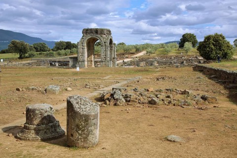 Tetrapylon and Roman archaeological site Ciudad Romana de Caparra with archway, Roman
