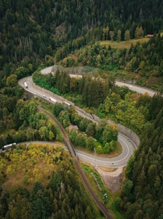 Serpentine road winds through dense forest in bird's eye view, Ravenna Gorge, Black Forest, Germany