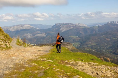 A woman enjoys a peaceful autumn hike in Gorbea Natural Park, Basque Country, Spain. Surrounded by