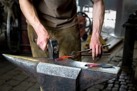 A blacksmith forging, working at the Ehnert forge in Dresden-Bühlau, Saxony, Germany