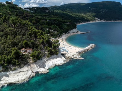 Stunning aerial view of Sirolo beach, Italy, showcasing turquoise waters, sandy shorelines, and