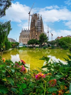 Basilica of the Sagrada Familia in Barcelona by the lake without people, Spain