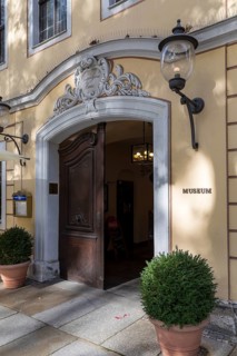 Portal with baroque decoration as the entrance to the Kügelgen Museum on the main street in
