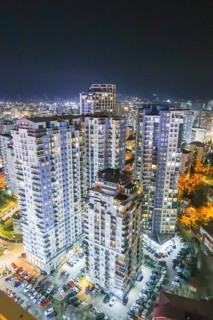 Stunning nighttime cityscape of Georgia showcasing modern high-rise buildings illuminated with