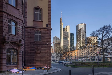 Several homeless people sleep in the morning near St. Paul's Church at the foot of Frankfurt's