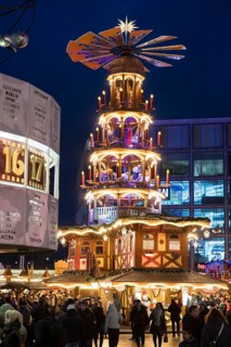 A Christmas pyramid behind the World Time Clock at the Christmas market on Alexanderplatz, Berlin,