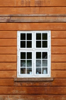 Window with white frame, rust-red house, Frederiksholms Canal, Copenhagen, Denmark