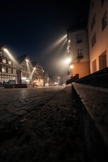 Night-time street scene with half-timbered houses and cobblestones, quietly and atmospherically