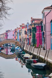 Colorful houses beside the waterway at 'Fondamenta di Terranova' with boats lying in the water on