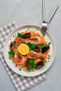 Seafood paella, shrimp and mussels risotto, rice, homemade, top view, no people