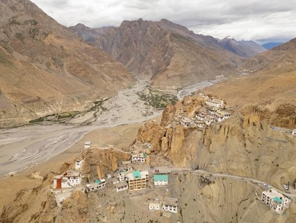 A stunning aerial view of Dhankar village and monastery nestled atop rocky cliffs in Spiti Valley,