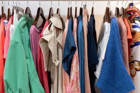 A vibrant racks displays various clothing styles, from casual to formal, in diverse colors and