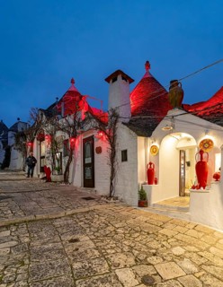 Street with Trulli houses by night, Rione Monti, Alberobello, Apulia - Puglia, Italy