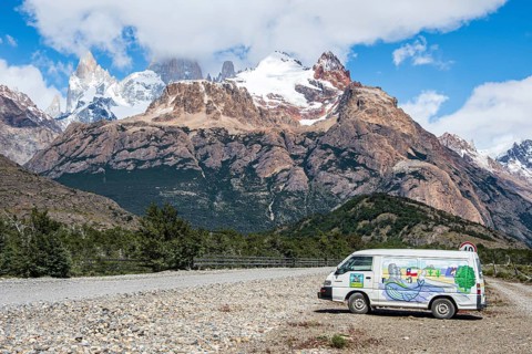 Painted camper van in front of Cerro Torre mountain range, road El Chalten - Lago del desierto,