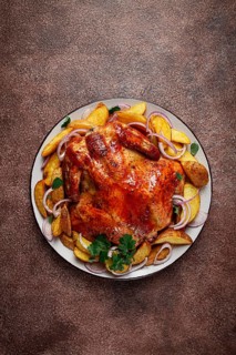 Fried, baked chicken, in the oven, with spices, and rustic potatoes, top view, homemade