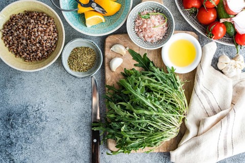 A vibrant selection of fresh ingredients for a healthy lunch, including rocket, oregano, cherry