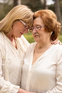 A touching moment between a mother and daughter as they share an embrace outdoors, highlighting
