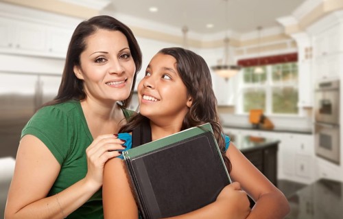 Proud Hispanic Mother and Daughter In Kitchen at Home Ready for School