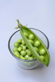 Fresh green peas in shell and pea pod, Pisum sativum