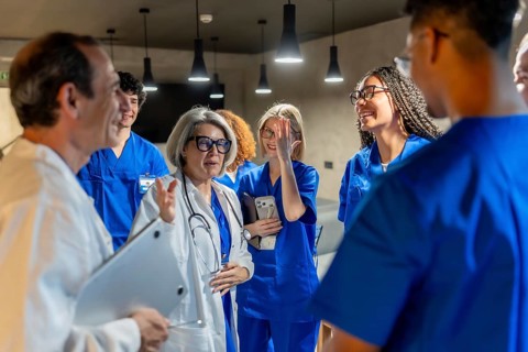 Group of multi ethnic healthcare professionals, including doctors, nurses, and medical students,