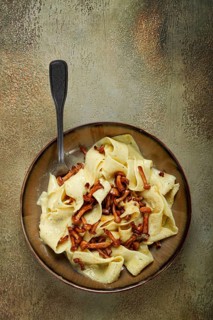 Pasta papardelle, in creamy garlic sauce, with mushrooms, traditional Italian cuisine, pasta