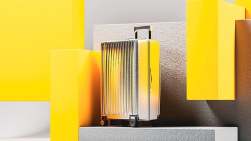 Vivid colored suitcase stands prominently on a minimalist display, highlighting sleek design and