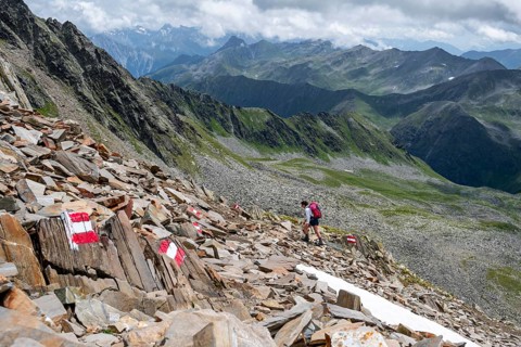 Red and white trail markings, hiker in the high mountains, Lasörling High Trail, Lasörling High