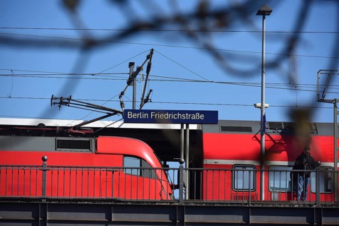 Berlin Friedrichstraße station train arriving at platform. A red train arrives at the platform of