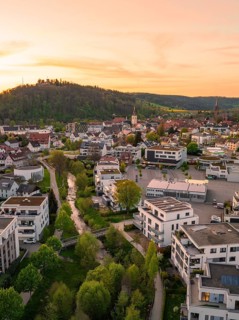 View of a town with a river surrounded by hills at sunset, Nagold, district of Calw, Germany