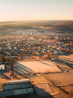 Overview of a town with houses and fields in the early morning light, Gechingen, Heckengäu region,